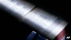 FILE - A scanner passes over a book at the University of Michigan in Ann Arbor, Michigan, March 21, 2008. The U.S. Supreme Court rejected a challenge that Google's digitizing of more than 20 million books amounted to copyright infringement.