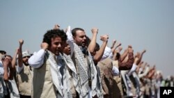 FILE - In this Oct. 16, 2020, file photo, Yemeni prisoners chant slogans during their arrival after being released by the Saudi-led coalition at the airport in Sanaa, Yemen.