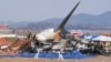 Firefighters and rescue team members work near the wreckage of a passenger plane at Muan International Airport in Muan, South Korea, Dec. 29, 2024.