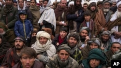 FILE - Hundreds of Afghan men gather for humanitarian aid in Qala-e-Naw, Afghanistan, on Dec. 14, 2021. The U.S. remains the largest aid donor to Afghanistan, and a report released July 17, 2024, says some U.S. aid could have ended up in the hands of extremists.