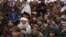 FILE - Hundreds of Afghan men gather for humanitarian aid in Qala-e-Naw, Afghanistan, on Dec. 14, 2021. The U.S. remains the largest aid donor to Afghanistan, and a report released July 17, 2024, says some U.S. aid could have ended up in the hands of extremists.
