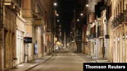An empty Via del Corso is seen following the imposition of a curfew from 10 p.m. to 5 a.m., as part of tougher measures to tackle the spread of the coronavirus disease (COVID-19), in Rome, Nov. 7, 2020.