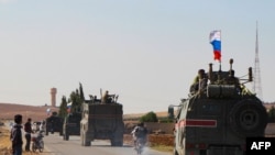 A convoy of Russian military vehicles heads for the Syrian city of Kobane, Oct. 23, 2019. Russian forces in Syria headed for the border with Turkey to ensure Kurdish fighters pull back after a Moscow-Ankara deal wrested control of the Kurds' heartland.