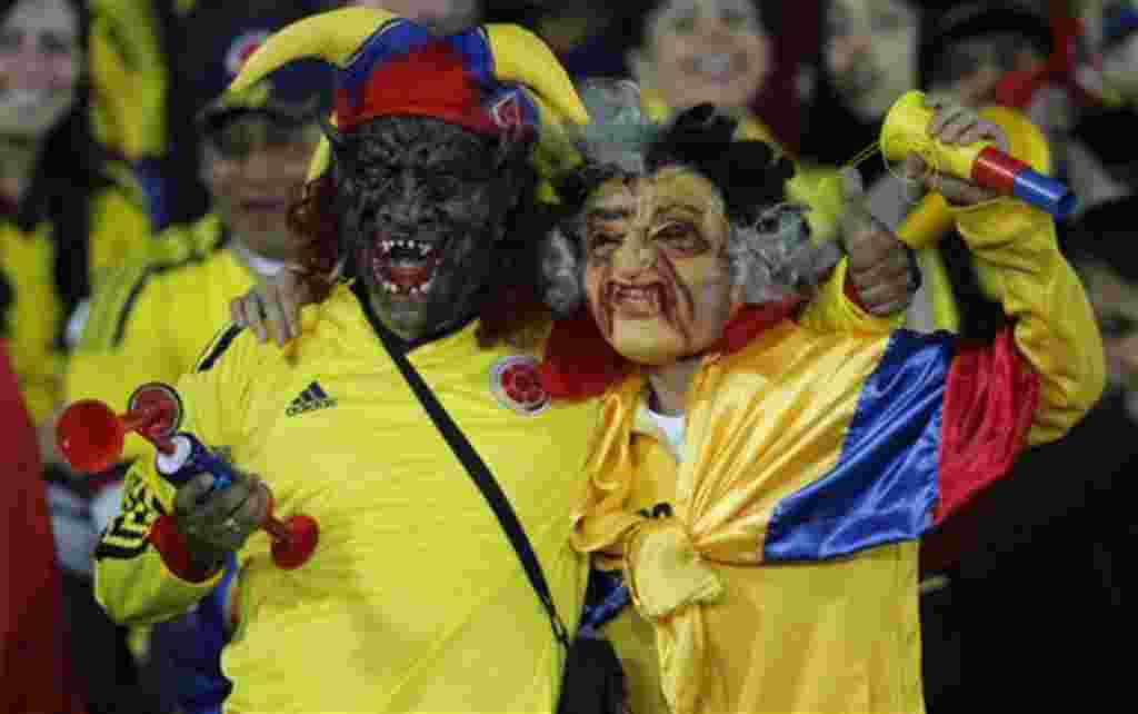 Wearing masks, Colombia's supporters cheer cheer his team during a U-20 World Cup group A soccer match against Mali in Bogota, Colombia, Tuesday, Aug. 2, 2011. (AP Photo/Dolores Ochoa)