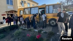 Residents board a bus during evacuation in Tikhoretsk, Krasnodar region, Russia, on Sept. 21, 2024, where Ukraine says it hit a munitions depot with long-range drones overnight. (Anatoly Perepelin on Telegram via Reuters)