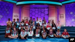 Participants with their medals to advance to the final round gathered on stage for a group photograph during the Scripps National Spelling Bee in Oxon Hill, Md., Wednesday, May 30, 2018.