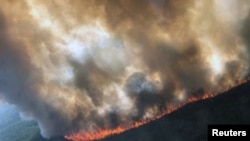 FILE - The Rainbow 2 Fire burning approximately 15 miles west of Delta Junction and west of the Tanana River near Delta Creek, Alaska, June 29, 2019, courtesy of Alaska Division of Forestry.