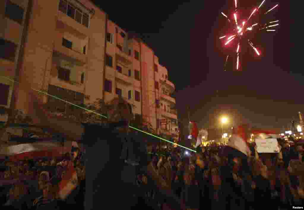 Anti-Morsi protesters set off fireworks and shine laser pointers on a road leading to the presidential palace in Cairo, Egypt, December 6, 2012.