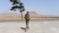 An Afghan National Army soldier walks on the outskirts of Herat on June 29, 2015.