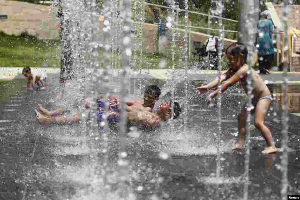 Children play in a water fountain just outside Jerusalem's Old City. A heatwave settled over Israel with temperatures reaching near 45 degrees Celsius (113 degrees Fahrenheit), according to Israel's Metereological Service. 