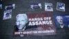 Banners in support of WikiLeaks founder Julian Assange are displayed outside Westminster magistrates court where he was appearing in London, Thursday, April 11, 2019.