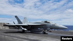 FILE - A F-18 jet launches off the USS Carl Vinson aircraft carrier during the Rim of the Pacific (RIMPAC) military exercises about 100 miles south of Oahu, Hawaii, U.S. July 19, 2024. (REUTERS/Marco Garcia)