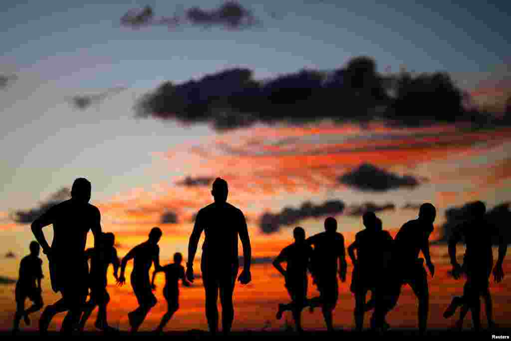 Youths train along the shore of the Mediterranean Sea in Ashkelon, Israel.