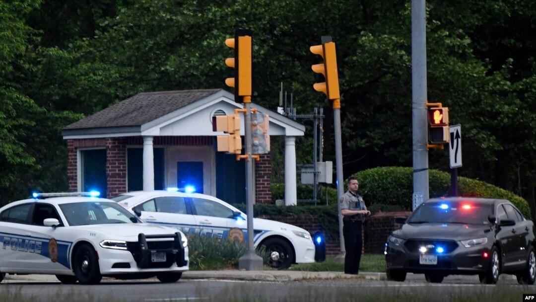 Police cars are seen outside the CIA headquarters gate after an armed man attempted to enter the compound earlier in the day in Langley, Virginia, May 3, 2021.