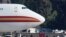 FILE - Women and children walk past personnel after arriving on an aircraft chartered by the U.S. to evacuate Americans from the Chinese city of Wuhan, at March Air Reserve Base in Riverside County, California, Jan. 29, 2020. 