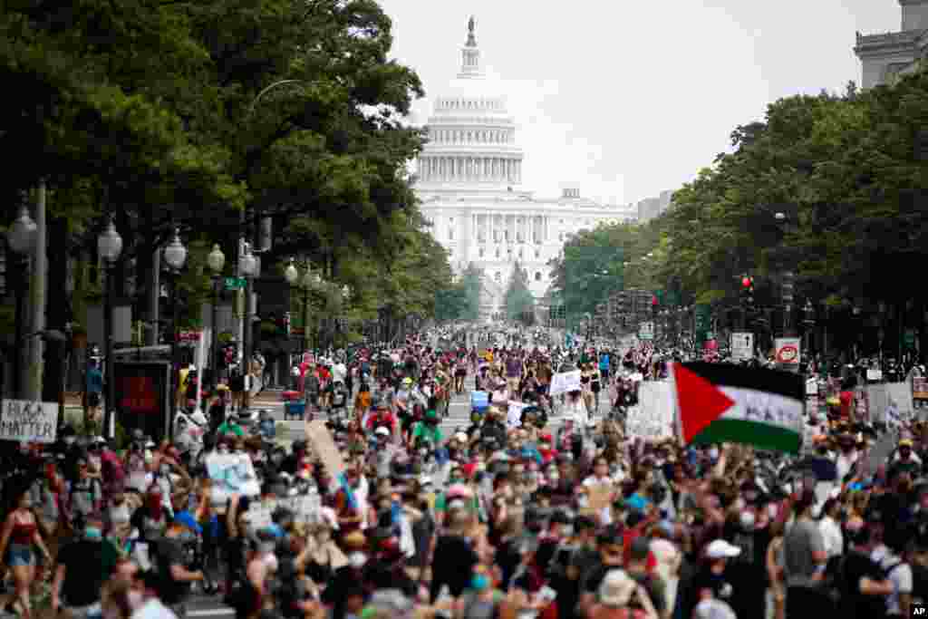 Demonstrators walk on Pennsylvania Avenue as they protest, June 6, 2020, in Washington.