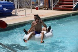 FILE - Guests play at the Golfland Sunsplash water park after COVID-19 restrictions eased in Mesa, Arizona, May 15, 2020.