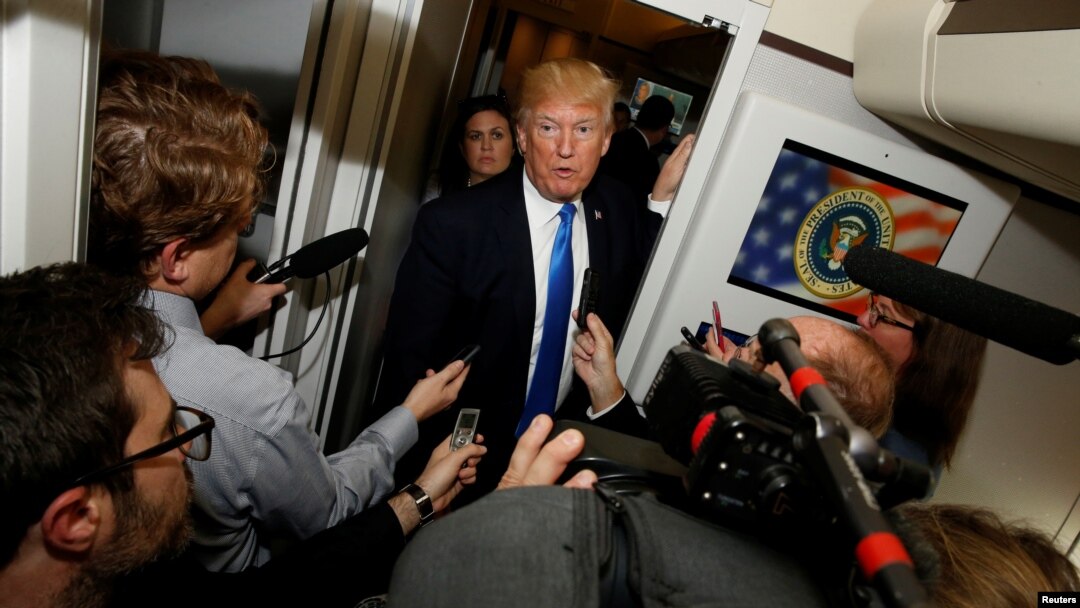FILE - U.S. President Donald Trump speaks to reporters in the press cabin aboard Air Force One, Nov. 14, 2017. 