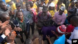 FILE - Zimbabwe opposition supporters gather at the funeral for Moreblessing Ali in Nyatsime a neighborhood on the outskirts of Harare, June, 14, 2022.