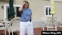 In this Aug. 24, 2020, photo Jean Grady smiles as she poses at her home in Westford, Vt. Grady wears an insulin pump to help manage her diabetes. (AP Photo/Wilson Ring) 