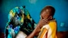 A mass rape victim comforts her son in the town of Fizi, Congo, Feb. 20, 2011. 