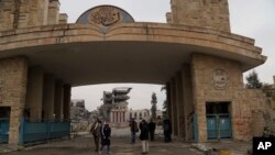 Students inspect their badly damaged university after it was recently liberated from Islamic State militants, Mosul, Iraq, Jan. 22, 2017. 