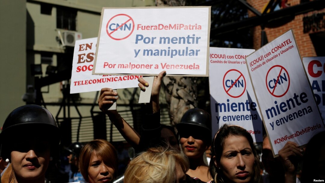 Supporters of Venezuela's President Nicolas Maduro hold placards during a gathering to support Maduro’s government order of suspension of CNN's Spanish-language service outside the National Commission of Telecommunications (CONATEL), in Caracas, Venezuela, Feb. 16, 2017. 