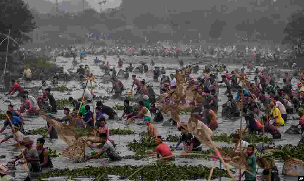 Villagers participate in community fishing as part of Bhogali Bihu celebrations in Panbari village, some 50 kilometers (31 miles) east of Gauhati, in the northeastern state of Assam, India.