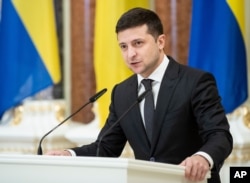 FILE - Ukrainian President Volodymyr Zelenskiy speaks in Kyiv, Dec. 4, 2019.