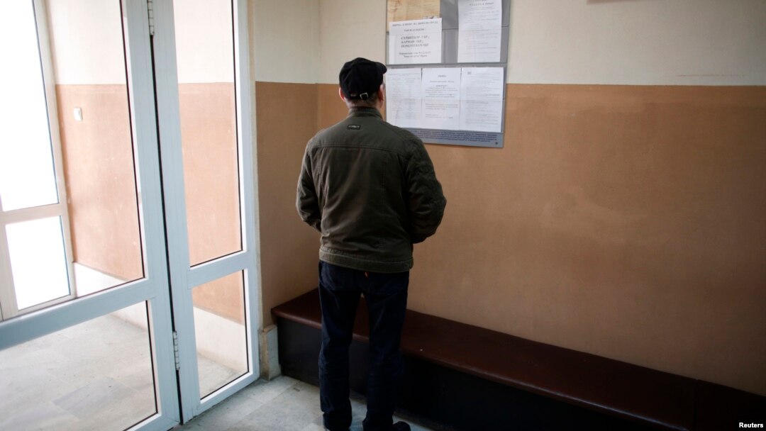 A man looks at a list with job vacancies posted at the entrance of an employment agency in the town of Vratsa, some 110km (68 miles) north of Sofia, Apr. 10, 2013. 