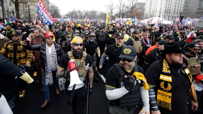 FILE - Supporters of then-President Donald Trump, wearing attire associated with the Proud Boys, attend a rally at Freedom Plaza, Dec. 12, 2020, in Washington.