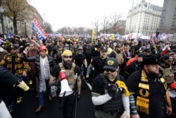 FILE - Supporters of President Donald Trump who are wearing attire associated with the Proud Boys attend a rally at Freedom Plaza, , Dec. 12, 2020, in Washington.