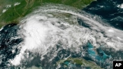 FILE - A satellite image taken June 18, 2021, and provided by NOAA, shows a tropical weather system in the Gulf of Mexico. Forecasters says a similar system currently developing might grow into a hurricane that could threaten parts of the southern U.S.