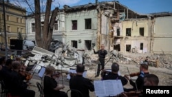 Members of the Kyiv Classic Orchestra perform "Requiem for the Dead" at the ruins of Okhmatdyt children's hospital, which was recently hit by a Russian missile, in Kyiv, Ukraine, July 12, 2024.