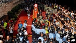 Riot police move in after fights broke out between China supporters and anti-government protesters at Amoy Plaza in the Kowloon Bay district in Hong Kong, Sept. 14, 2019.