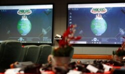 FILE - Monitors are illuminated in the NORAD Santa tracking center at Peterson Air Force Base in Colorado Springs, Colo., in this Dec. 23, 2019, photo.