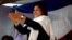 Wife of ex-president Marc Ravalomanana, Lalao Ravalomanana (C) applauds during an electoral meeting on May 4, 2013 in Antananarivo at "the Magro", a supermarket owned by her husband.