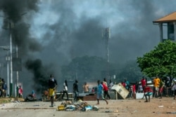 FILE - Supporters of Guinean opposition leader Cellou Dalein Diallo clash with police in Conakry, Oct. 21, 2020. Diallo declared himself winner against incumbent President Alpha Conde in Sunday's presidential elections.