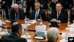 U.S. Secretary of State Mike Pompeo, right, and U.S. Ambassador to Russia Jon Huntsman, second left, listen to Russian Foreign Minister Sergey Lavrov, left, back to a camera, during their talks in the Black Sea resort city of Sochi, southern Russia, May 1