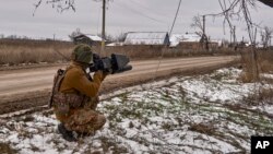 FILE - In this photo provided by the Ukrainian 10th Mountain Assault Brigade "Edelweiss," a Ukrainian soldier holds an anti-drone gun on his position near Bakhmut, Donetsk region, Ukraine, Nov. 23, 2023. Ukraine's military reported shooting down five Russian drones Dec. 18, 2023.