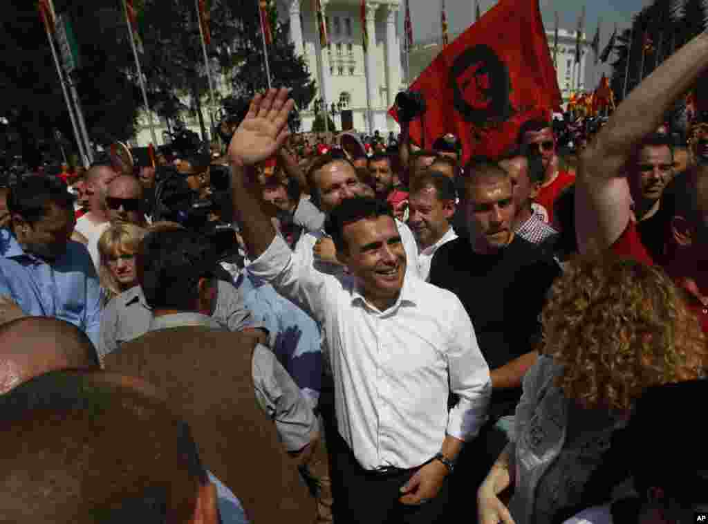 Zoran Zaev, center, the leader of the opposition social democrats, waves to the supporters during a protest in front of the Government building in Skopje, May 17, 2015.