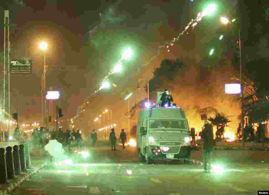 Protesters throw fireworks at police during clashes in front of the presidential palace in Cairo, Feb. 1, 2013.