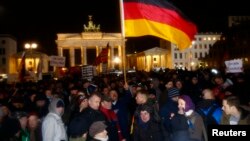 Members of BAERGIDA, Berlin's section of anti-immigration movement Patriotic Europeans Against the Islamisation of the West (PEGIDA) demonstrate in front of Berlin's Brandenburg Gate, Germany, Jan. 12, 2015.