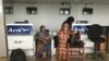 Stranded passengers stand at the closed Arik Air check-in counter following a protest over unpaid salaries by staff in Lagos, Nigeria, Tuesday, Dec. 20, 2016.