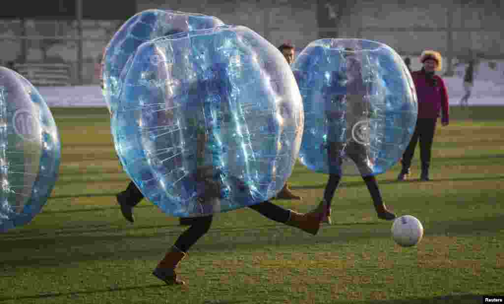 Participants play a game of bubble bump soccer during an amateur championship in Almaty, Kazakhstan, Jan. 11, 2014. The game is played by five-a-side teams wearing inflatable balls trying to score goals against the opposing team.&nbsp;