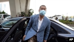 In this Thursday, Oct. 15, 2020 photo, Jimmy Lai arrives at a court in Hong Kong. Jimmy Lai, the pro-democracy Hong Kong media tycoon who was arrested during a crackdown on dissent was charged Wednesday Dec. 2, 2020, with fraud but no national…