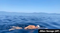 This Aug. 1, 2021 image shows James Savage, 14, as he swam the entire length of Lake Tahoe. This makes him the youngest person to do so. (AP Photo/By Jillian Savage)