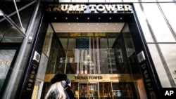 FILE - Pedestrians pass security barricades in front of Trump Tower, Feb. 17, 2021, in New York. Former President Donald Trump owns a penthouse condominium in the skyscraper and the Trump Organization has its headquarters there.