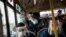 Commuters wearing protective face masks and face shields travel on a public bus in Lima, Peru, July 22, 2020. 