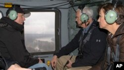 Vice President Mike Pence, center, tours in a helicopter over areas flooded by the Missouri and Elkhorn rivers, with Iowa Gov. Kim Reynolds, right, and Neb. Gov. Pete Ricketts, left, March 19, 2019. 